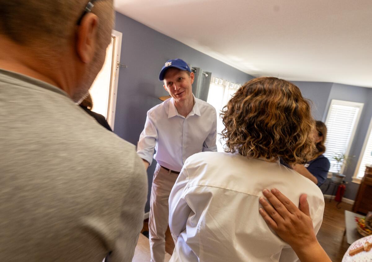 George Whitesides greets residents as he canvasses a neighborhood in Palmdale