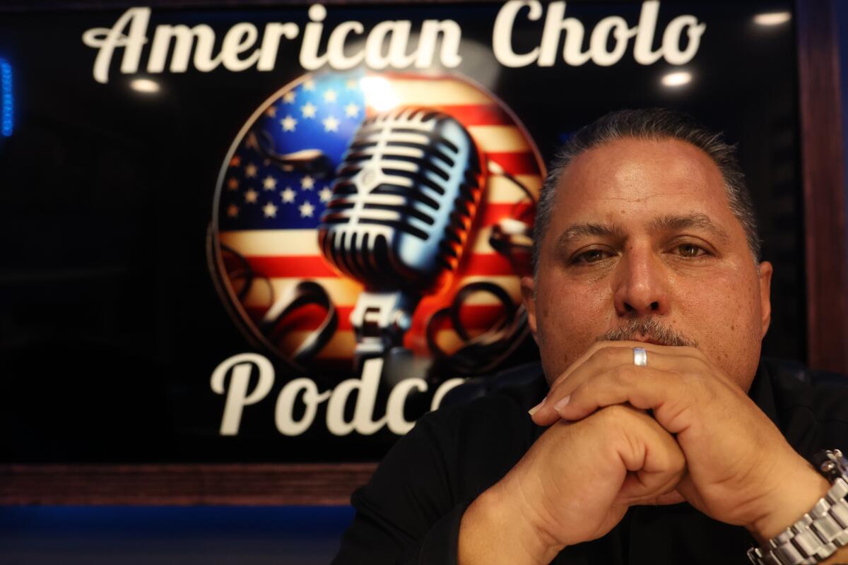 Gill Tejada poses for a portrait before he records an episode of his 'American Cholo' podcast.